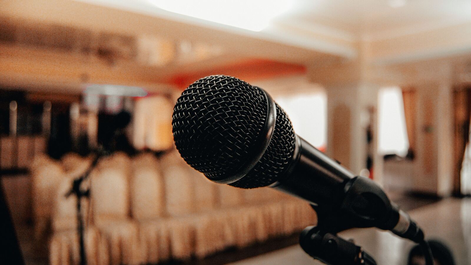 Global Business Consulting and Training 129 Microphone on a stand in front of an empty audience hall